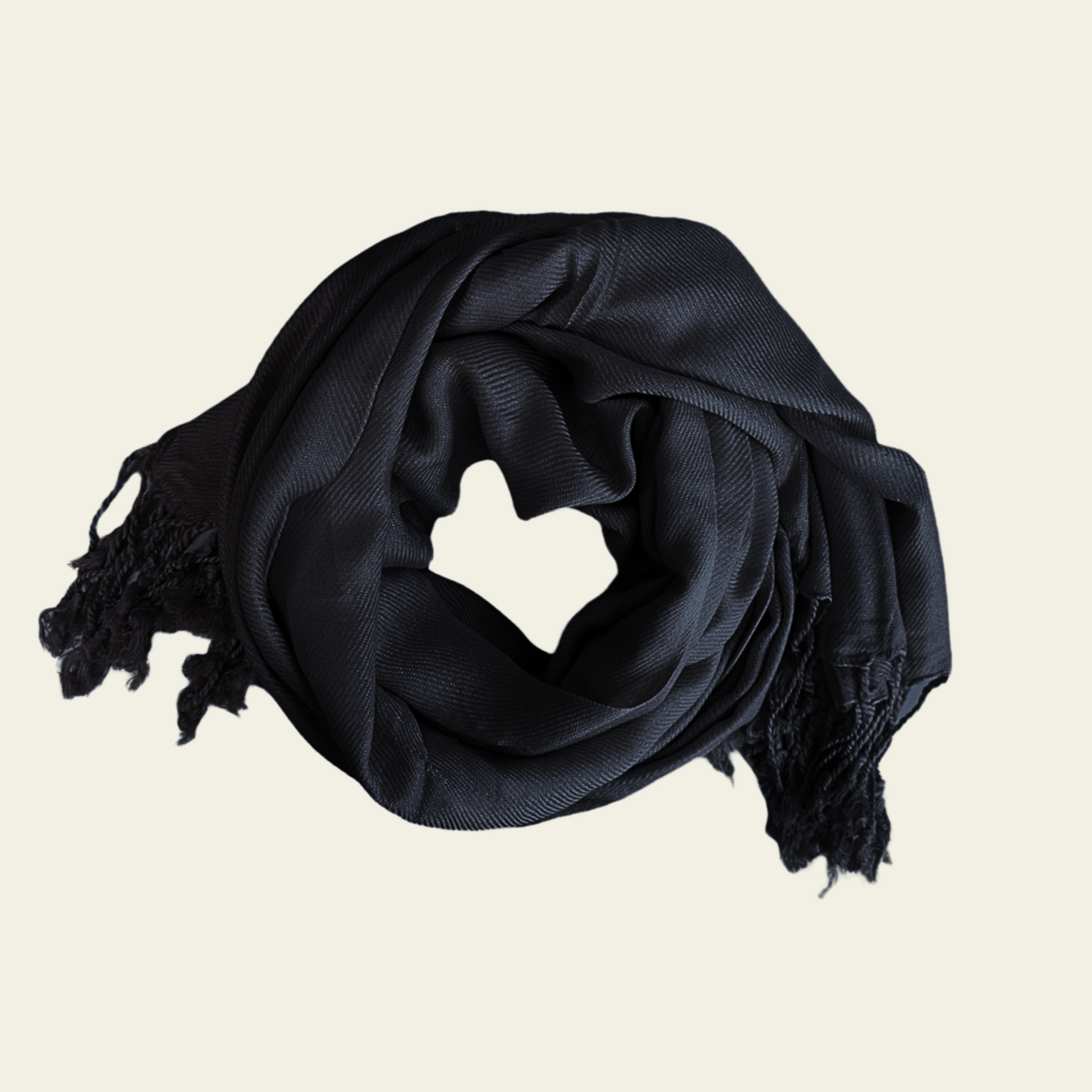 This black pashmina is elegantly displayed rolled up as a scarf, showcasing its soft, luxurious fabric and versatile design. The deep black color offers a timeless, classic appeal, making it a perfect accessory to complement any outfit. Lightweight yet warm, the pashmina can be worn in various ways—whether draped over the shoulders or wrapped around the neck—for a chic and cozy look.