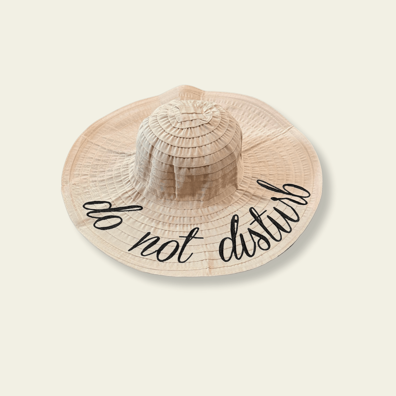 This beige crushable hat features the playful and bold "do not disturb" quote printed on the front, making it the perfect accessory for those times when you’re ready to unwind. The hat is made from soft, flexible material that can easily be folded or packed without losing its shape, making it ideal for travel, weekend getaways, or relaxing days off.