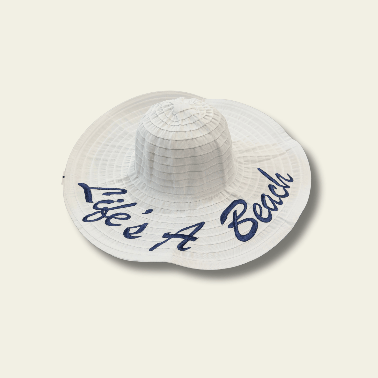 This white crushable hat features the fun and playful "Life's a beach" quote printed on the front, making it the perfect accessory for your next vacation or relaxed day out. The hat is made from soft, flexible material that can be easily folded or packed without losing its shape, making it ideal for travel