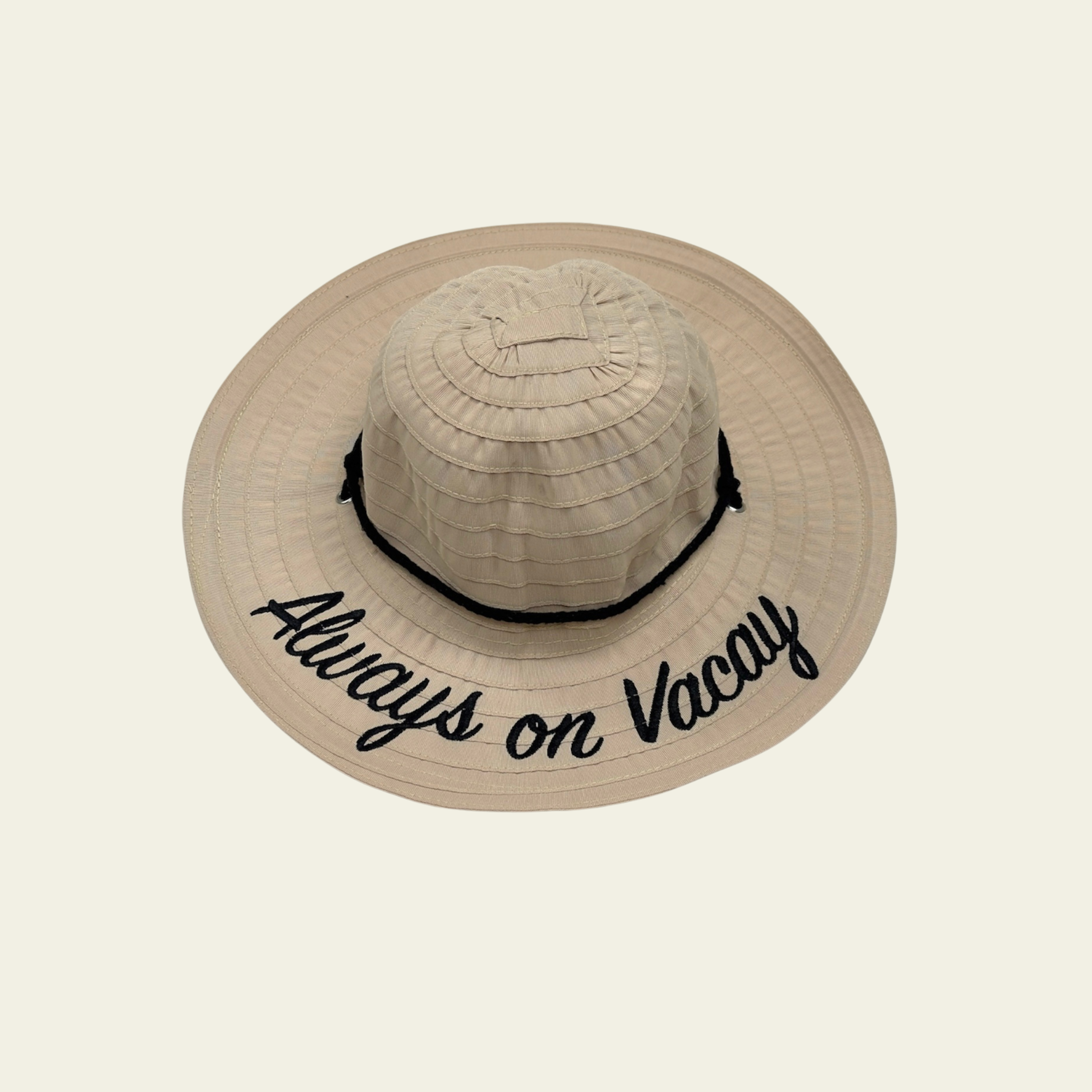 This kids' hat features a beige crushable design, making it easy to pack and store when not in use. Made from lightweight, durable fabric, it is designed to provide comfort and sun protection. The hat features a printed quote on the front, adding a fun and personal touch to your child's outdoor attire. Ideal for travel, beach trips, or casual wear, this hat can be easily packed without losing its shape.