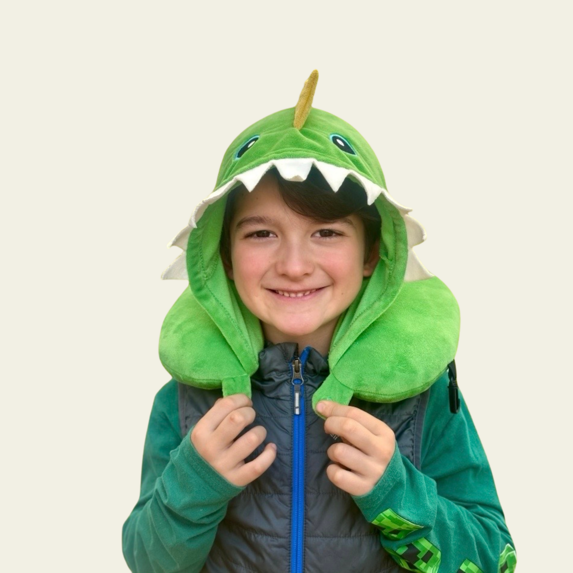 This adorable neck pillow with a hood for kids is designed to provide comfort and support during travel. Shaped like a cute green dinosaur, it offers a fun and cozy experience for children while they rest on long car rides, flights, or during naps. The soft and plush material ensures comfort, while the pillow’s ergonomic design helps support the neck for a more relaxed journey.