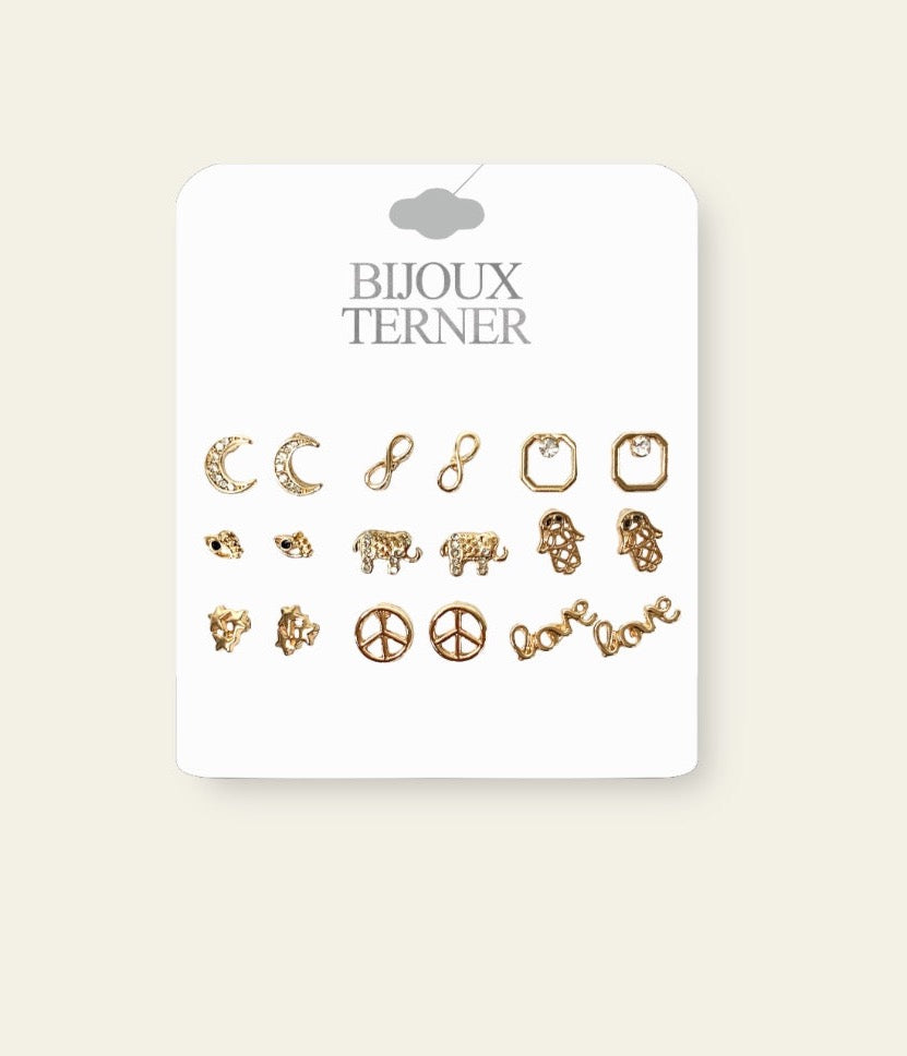 The Celestial 9-Piece Stud Set features nine unique gold stud earrings, each with a distinct shape and design, offering a variety of symbolic meanings. This collection includes studs representing love, peace, an eye, the moon, the infinity symbol, and other celestial-inspired motifs. The delicate gold finish adds a touch of elegance, while the variety of designs allows for personal expression and easy mix-and-matching.