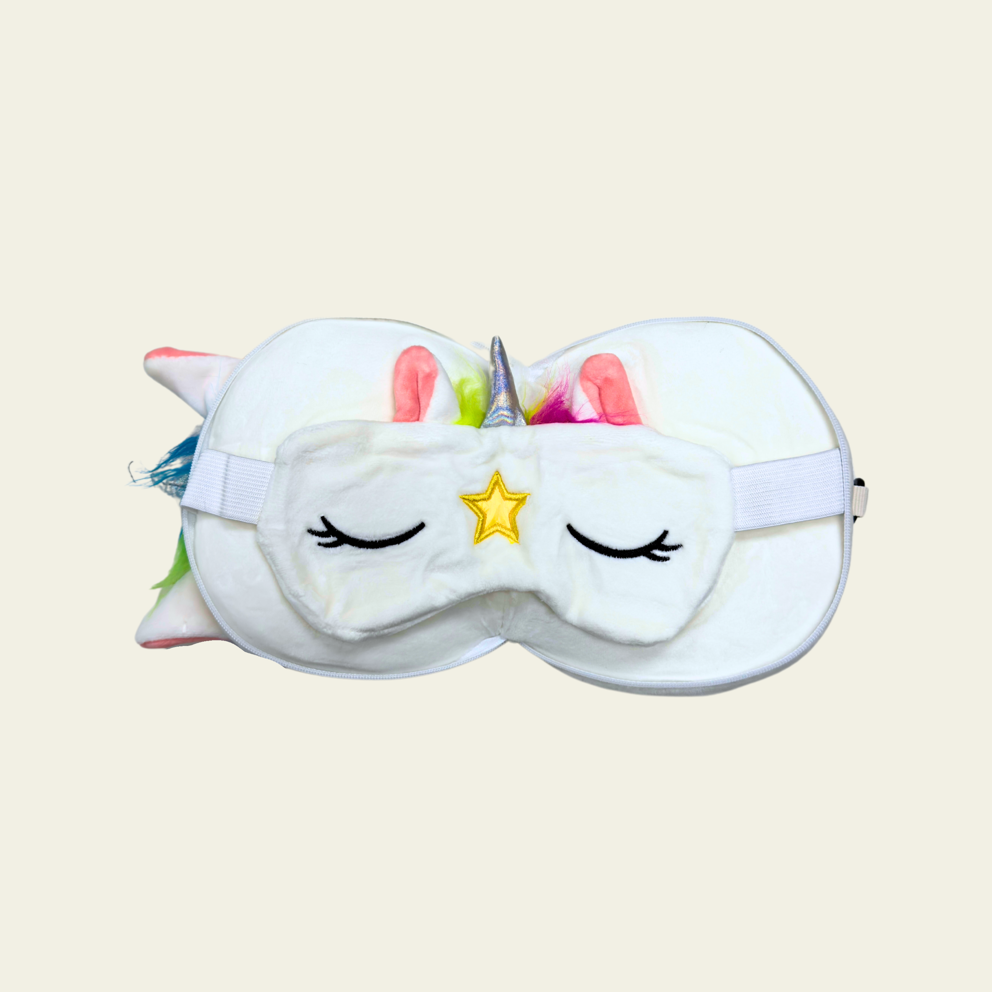 This soft and comfortable eye mask pillow for kids is designed in the shape of a cute white unicorn. The pillow is made of high-quality, gentle materials to provide a cozy and relaxing experience for children. It helps block out light for a restful sleep or nap, making it perfect for travel or bedtime. The pillow is lightweight and features a fun, whimsical unicorn design with a white color and colorful accents.